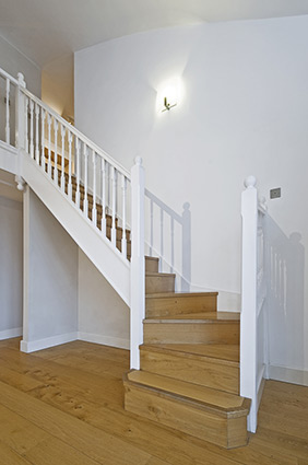 Interior stairway with a glass railing.